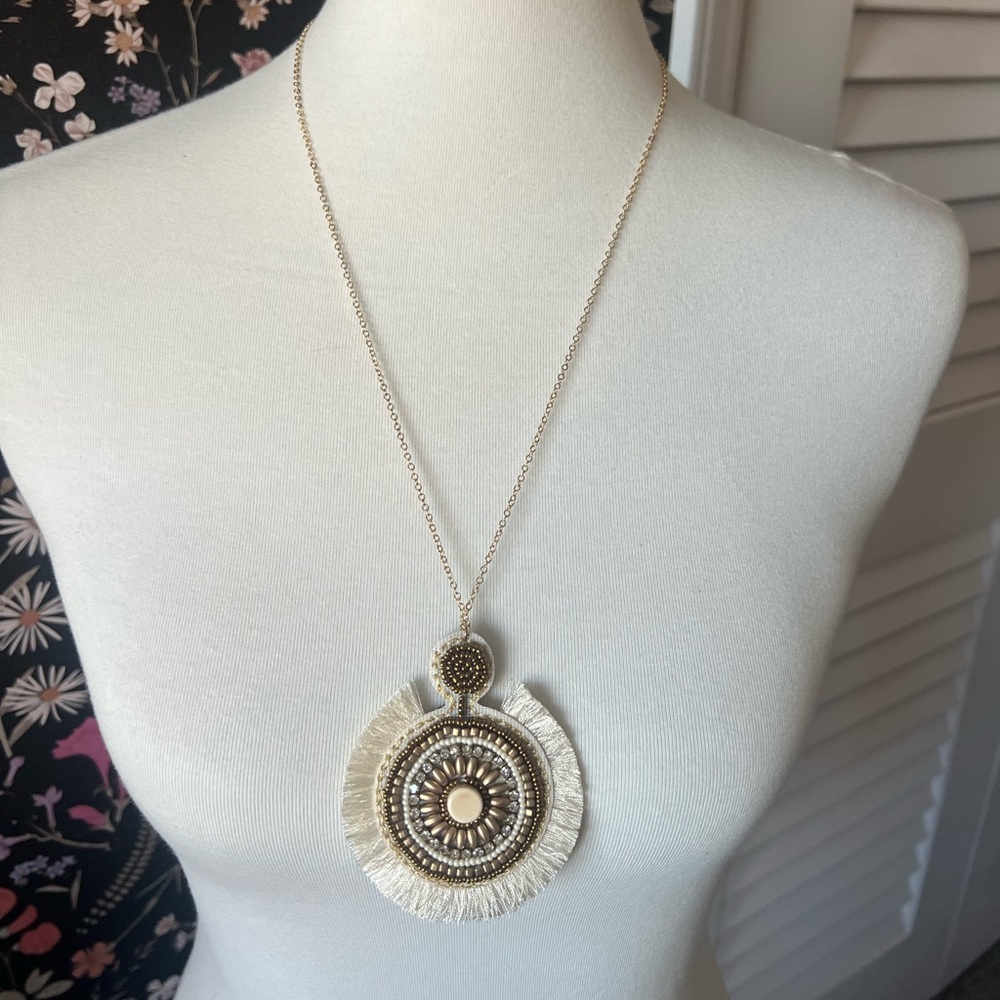 White/cream and gold statement necklace.